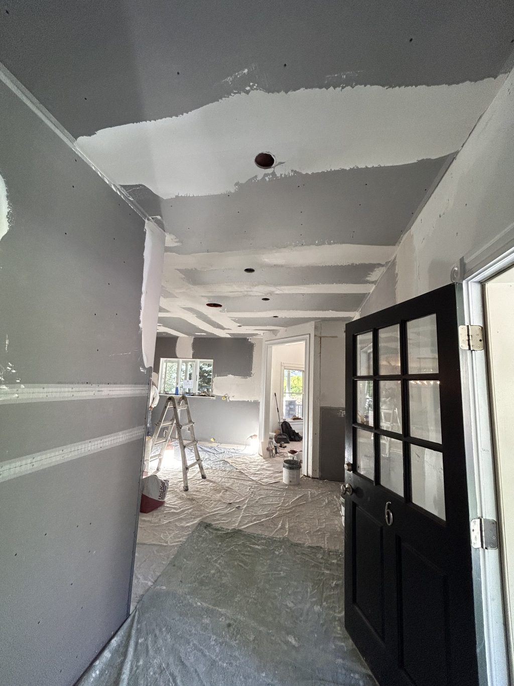 Drywall hung and taped in a remodeled kitchen and entry