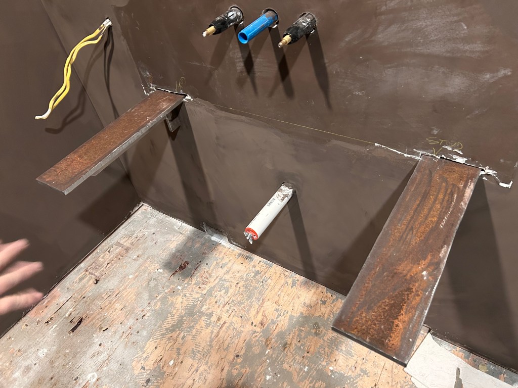 Steel support brackets and rough plumbing set for a floating vanity